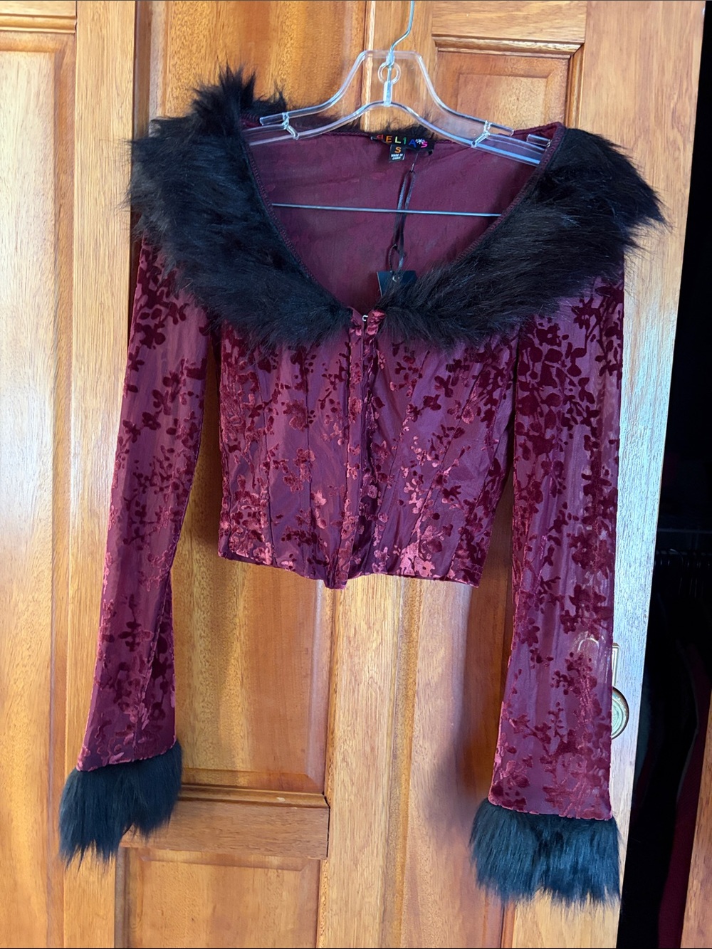 Burgundy long sleeve top with black fur hem and hook clips